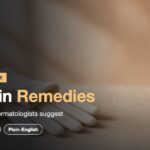 Dry skin remedies: an amber pump bottle and cream cotton gloves on a sand-colored linen surface